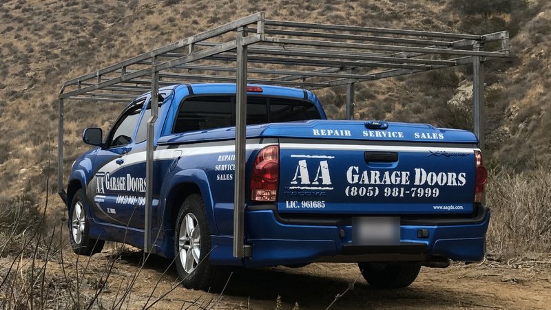 Rear view of the AA Garage Doors service truck showing Repair, Service, Sales and CA license 961685