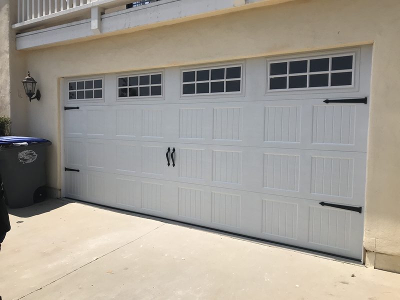 Almond carriage house with window tops garage door installed by AA Garage Doors