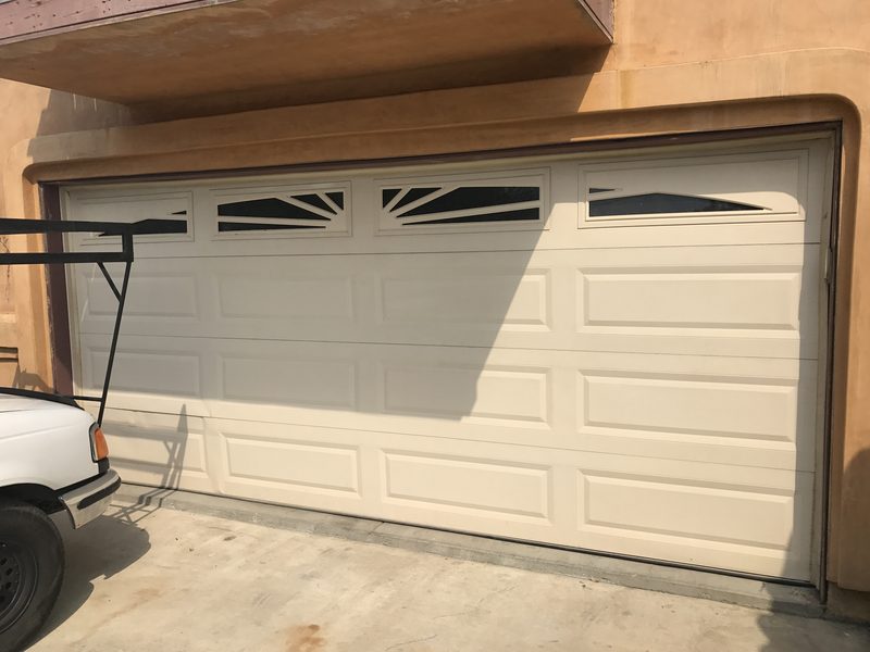 Almond raised panel, arched windows garage door installed by AA Garage Doors