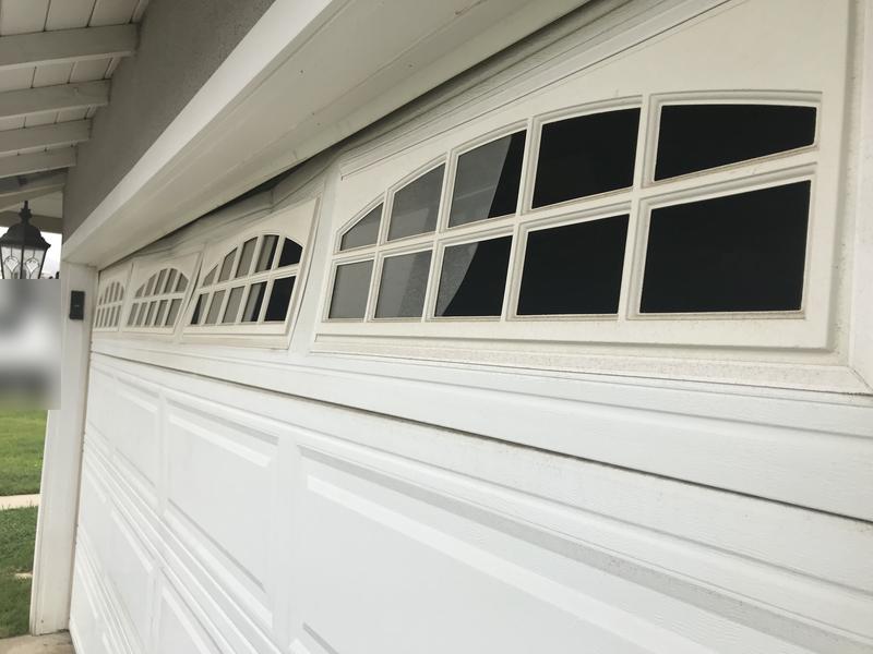 Garage door with a bowed top section with windows