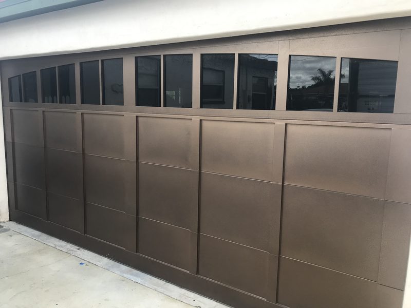 Bronze flush door with a row of windows garage door installed by AA Garage Doors