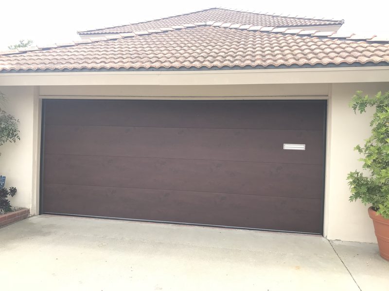 Dark brown flush door garage door installed by AA Garage Doors