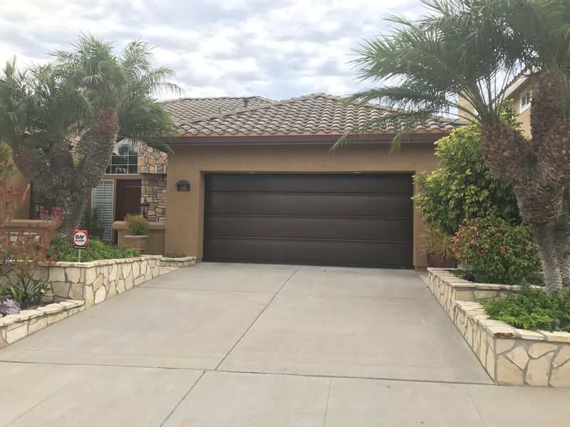 Dark brown door, tile-roof home garage door installed by AA Garage Doors