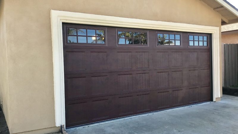 Brown raised panel, window tops garage door installed by AA Garage Doors