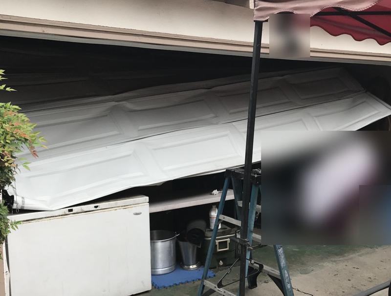 Garage door collapsed off its tracks into the garage