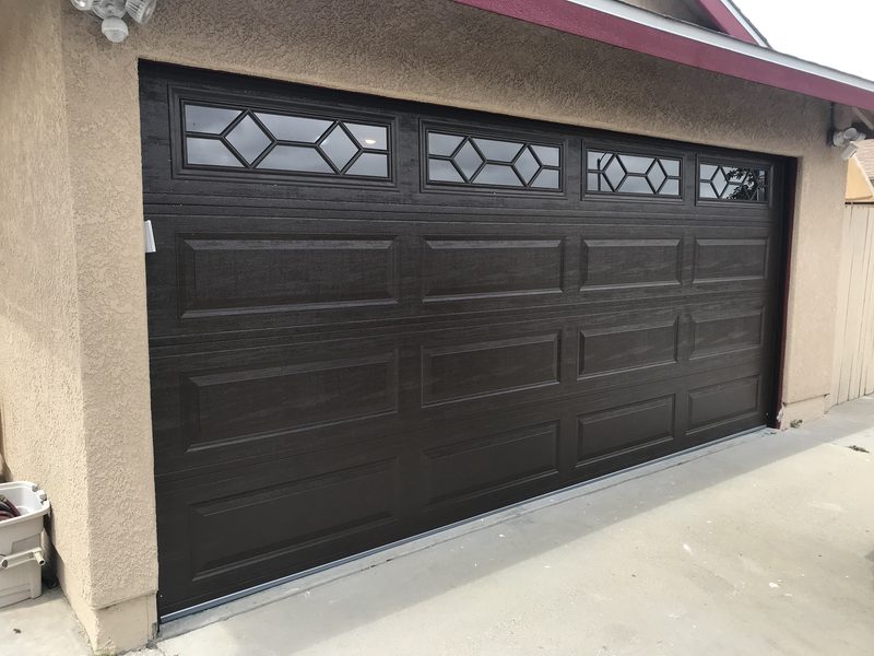 Dark brown, diamond windows garage door installed by AA Garage Doors