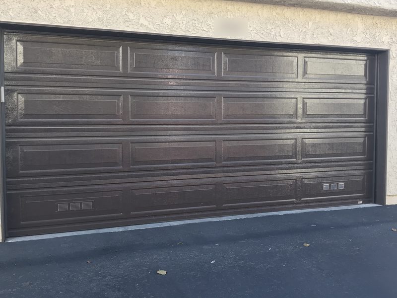 Dark wood-grain, long panels garage door installed by AA Garage Doors