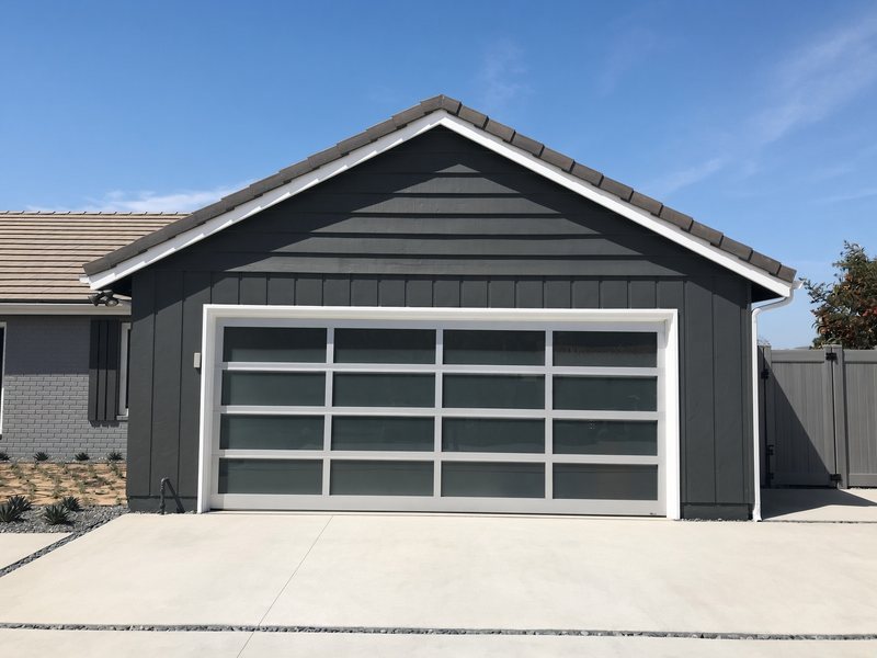 Modern full-view aluminum garage door with frosted glass panels