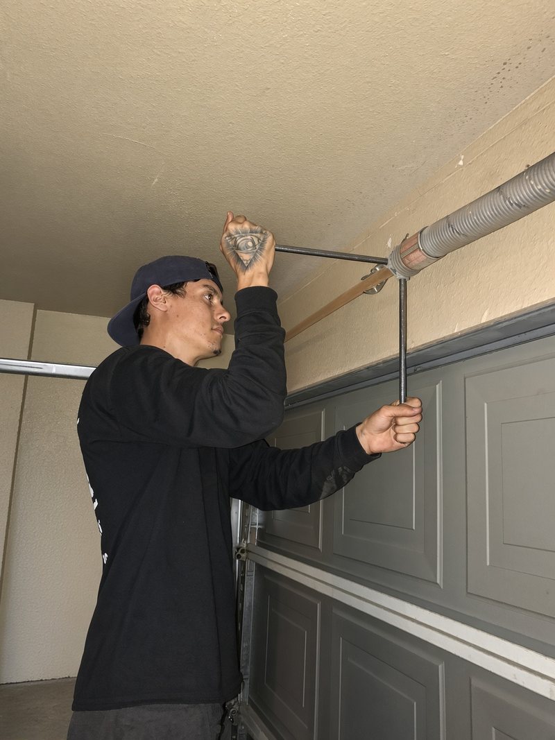 Alex's son winding a garage door torsion spring