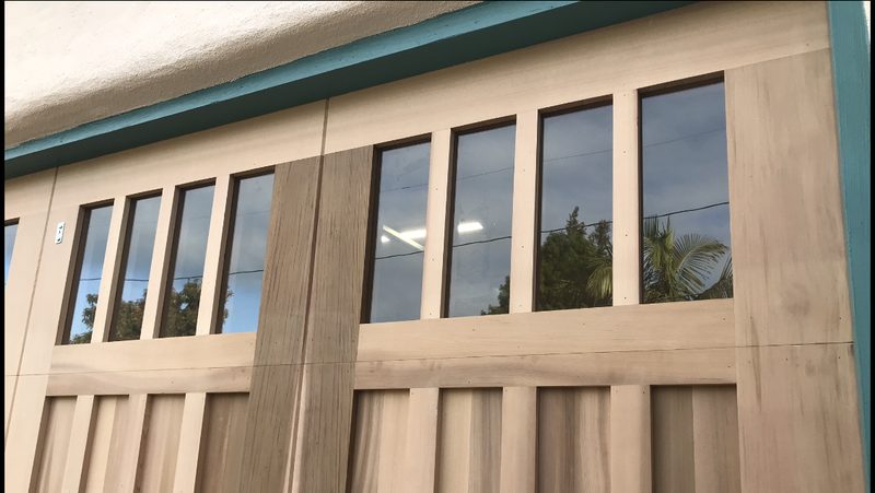 Stained wood-look doors, tall windows garage door installed by AA Garage Doors