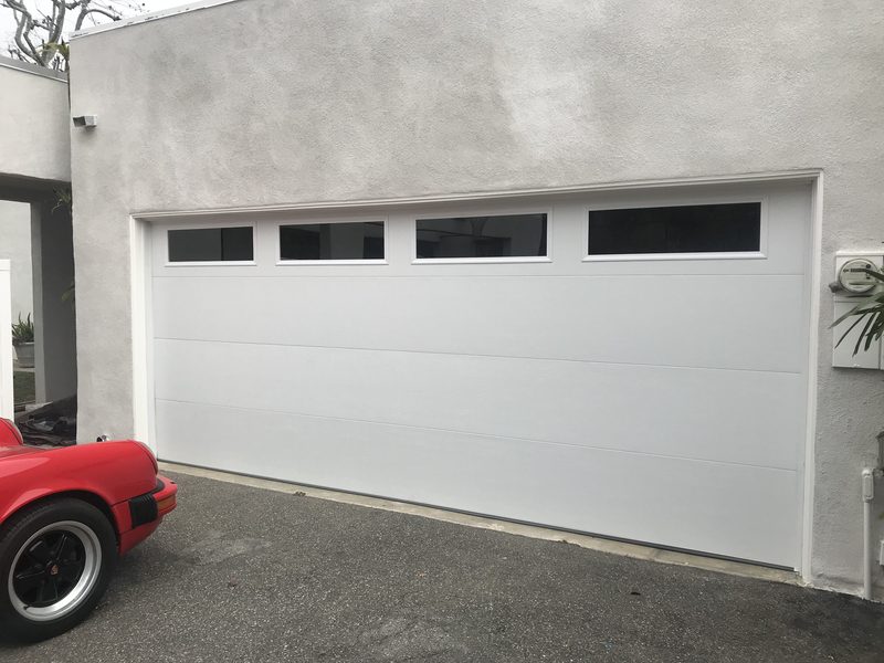 White door, long window tops garage door installed by AA Garage Doors