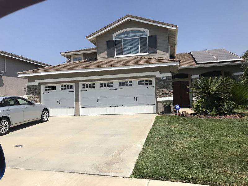 White doors, two-story home garage door installed by AA Garage Doors