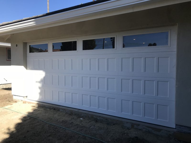 White raised panel, window tops garage door installed by AA Garage Doors
