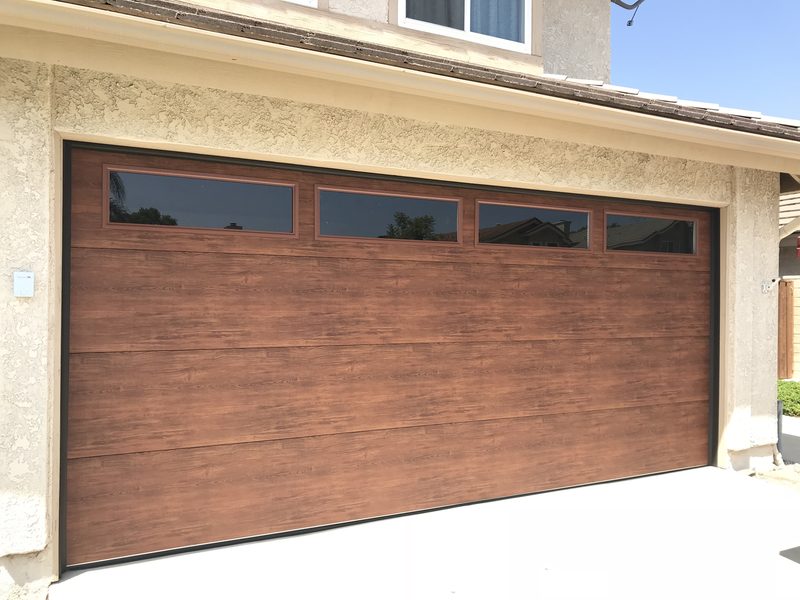 Wood-grain finish, long window tops garage door installed by AA Garage Doors
